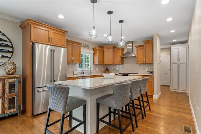 4 Kestrel Way, Carver, MA 02330 - kitchen featuring high quality fridge, wall chimney exhaust hood, recessed lighting, tasteful backsplash, and a center island