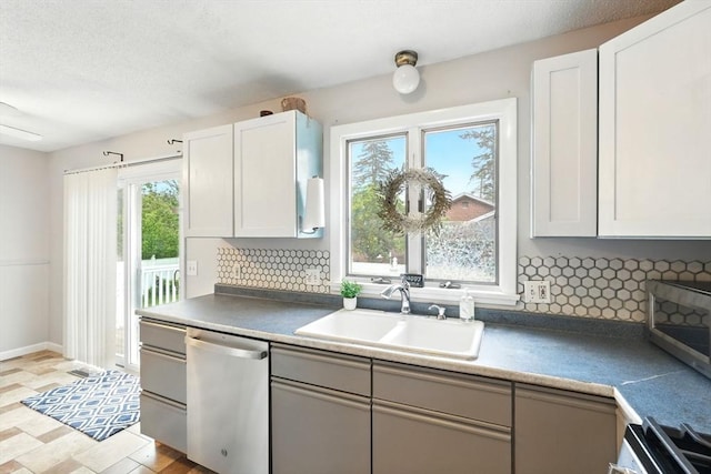 19 Arnold Ave, Chicopee, MA 01013 - kitchen with appliances with stainless steel finishes, a sink, tasteful backsplash, and white cabinetry