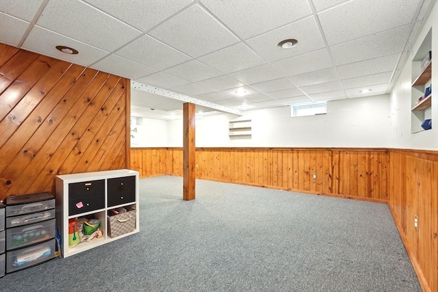 19 Arnold Ave, Chicopee, MA 01013 - below grade area with wood walls, a drop ceiling, carpet flooring, and a wainscoted wall