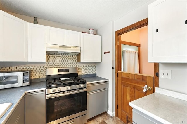 19 Arnold Ave, Chicopee, MA 01013 - kitchen with stainless steel appliances, under cabinet range hood, white cabinets, decorative backsplash, and a sink