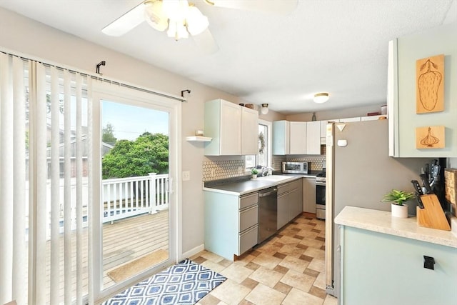 19 Arnold Ave, Chicopee, MA 01013 - kitchen with stainless steel appliances, a sink, backsplash, light countertops, and a ceiling fan