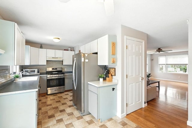 19 Arnold Ave, Chicopee, MA 01013 - kitchen with stainless steel appliances, under cabinet range hood, a ceiling fan, a sink, and decorative backsplash