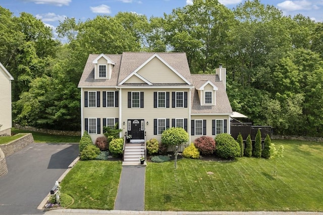 66 Saville, North Andover, MA 01845 - view of front of home featuring a front lawn, a shingled roof, and asphalt driveway