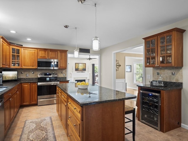 66 Saville, North Andover, MA 01845 - kitchen with stainless steel appliances, wine cooler, tasteful backsplash, a breakfast bar, and light tile patterned flooring