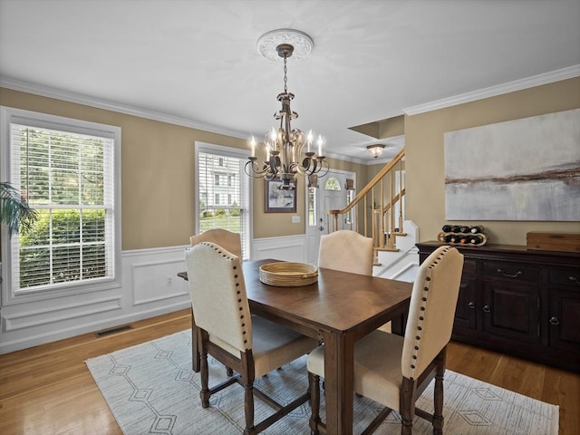 66 Saville, North Andover, MA 01845 - dining room with a chandelier, stairs, crown molding, plenty of natural light, and light wood finished floors