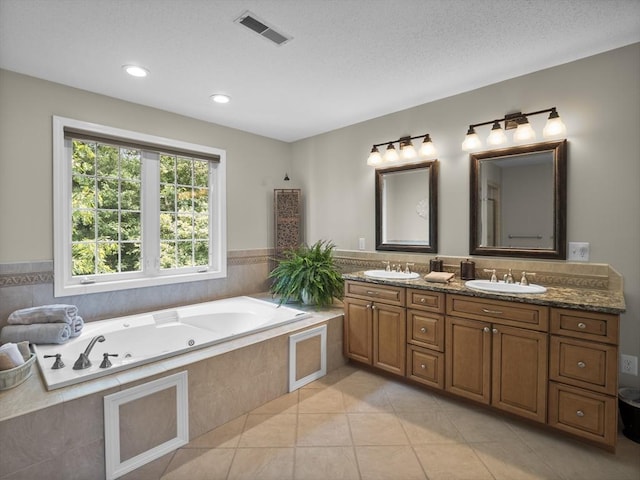 66 Saville, North Andover, MA 01845 - full bath featuring double vanity, a jetted tub, tile patterned flooring, recessed lighting, and a textured ceiling