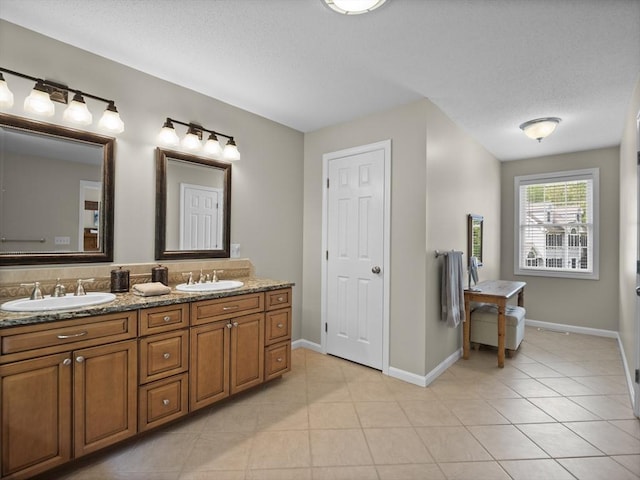 66 Saville, North Andover, MA 01845 - bathroom with double vanity, tile patterned floors, and baseboards