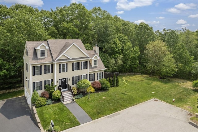 66 Saville, North Andover, MA 01845 - view of front of home featuring a front yard, a chimney, and roof with shingles