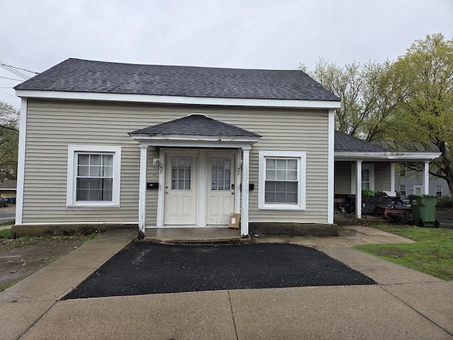 view of front of home featuring a porch and roof with shingles