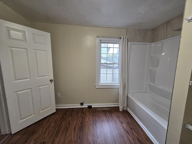 full bath featuring baseboards, shower / bathing tub combination, wood finished floors, and visible vents