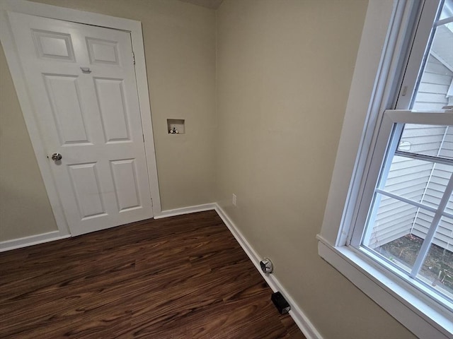 laundry area with washer hookup, baseboards, laundry area, and dark wood finished floors