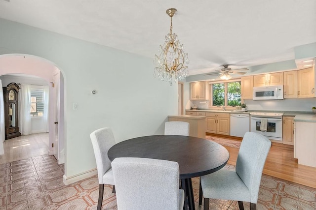 68 Shelton Rd, Swampscott, MA 01907 - dining room featuring arched walkways, ceiling fan, a chandelier, and baseboards
