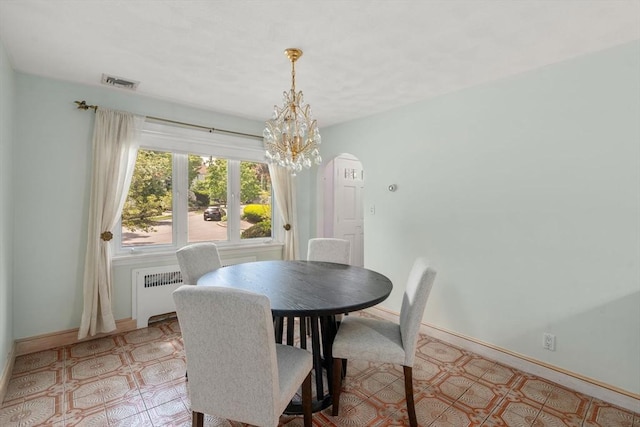 68 Shelton Rd, Swampscott, MA 01907 - dining room with radiator, arched walkways, light floors, and baseboards