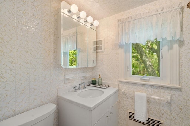 68 Shelton Rd, Swampscott, MA 01907 - bathroom featuring healthy amount of natural light, tile walls, vanity, toilet, and radiator