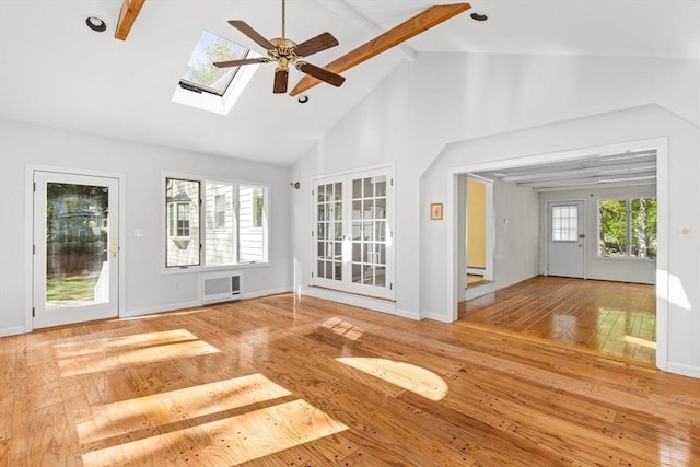 unfurnished living room featuring beamed ceiling, wood-type flooring, high vaulted ceiling, ceiling fan, and a skylight