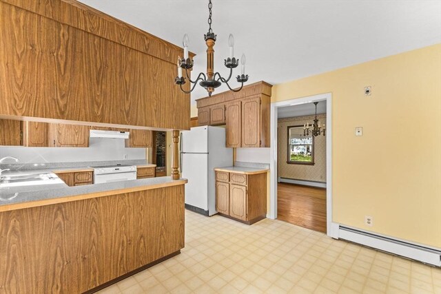 kitchen featuring a chandelier, white appliances, under cabinet range hood, light flooring, and a baseboard heating unit