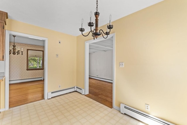 empty room featuring a chandelier, a baseboard heating unit, baseboard heating, and light flooring