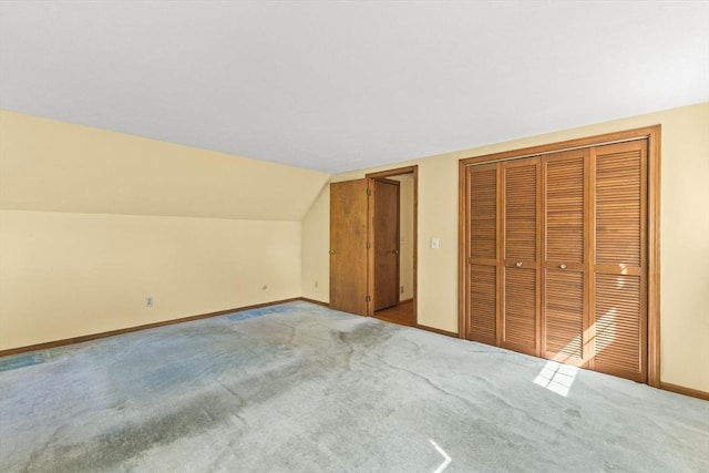bonus room with baseboards, carpet floors, and vaulted ceiling