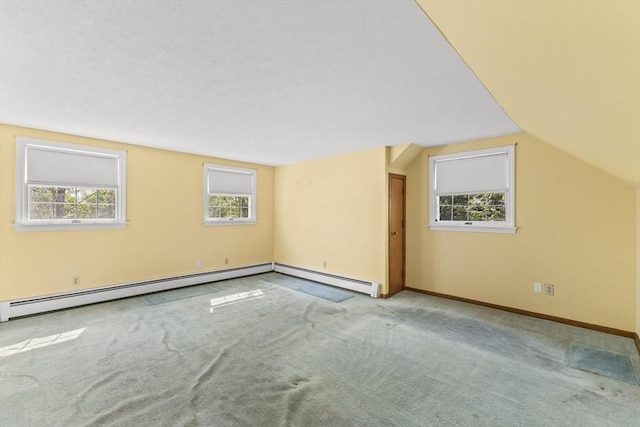 bonus room featuring healthy amount of natural light, carpet flooring, baseboards, and lofted ceiling