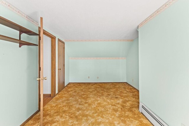 spare room with carpet, baseboard heating, and baseboards