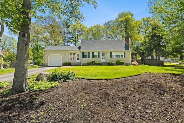 view of front of property featuring a garage, driveway, and a chimney