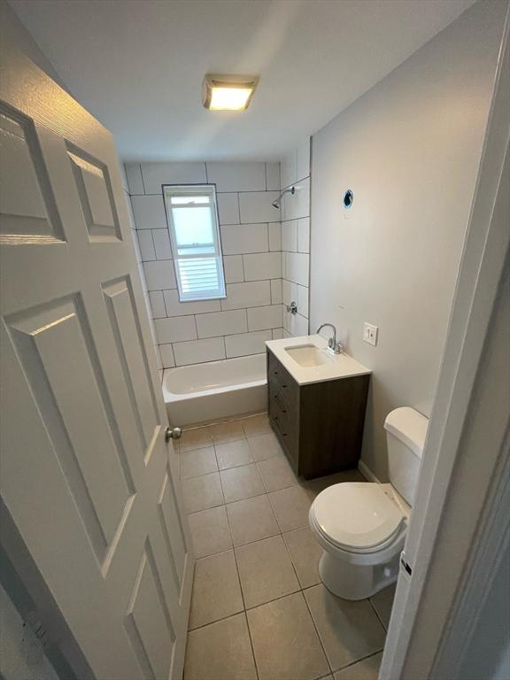 full bath with tile patterned flooring, vanity, toilet, and shower / washtub combination