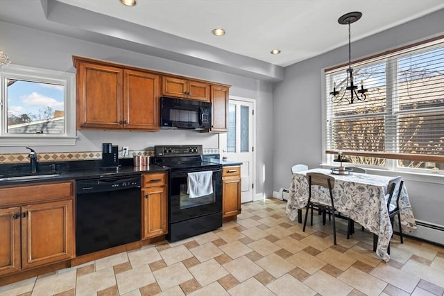 kitchen featuring a sink, a baseboard heating unit, brown cabinets, and black appliances