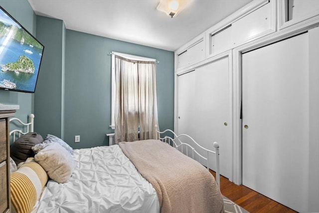 bedroom with dark wood-style flooring