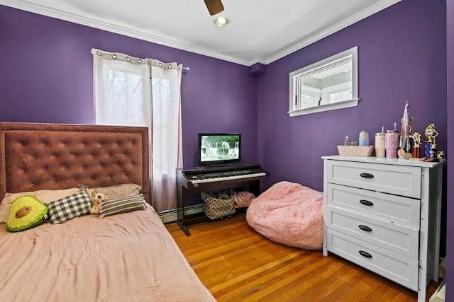 bedroom featuring baseboard heating, ornamental molding, a ceiling fan, and wood finished floors