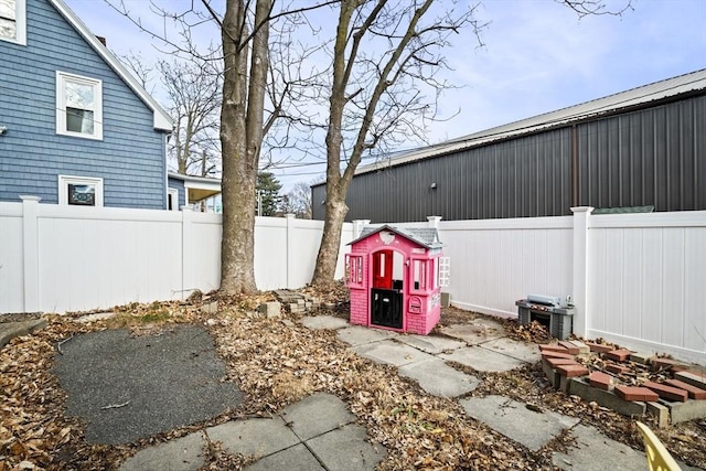 view of yard with central air condition unit and a fenced backyard