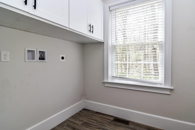 clothes washing area with visible vents, dark wood-style flooring, baseboards, electric dryer hookup, and cabinet space