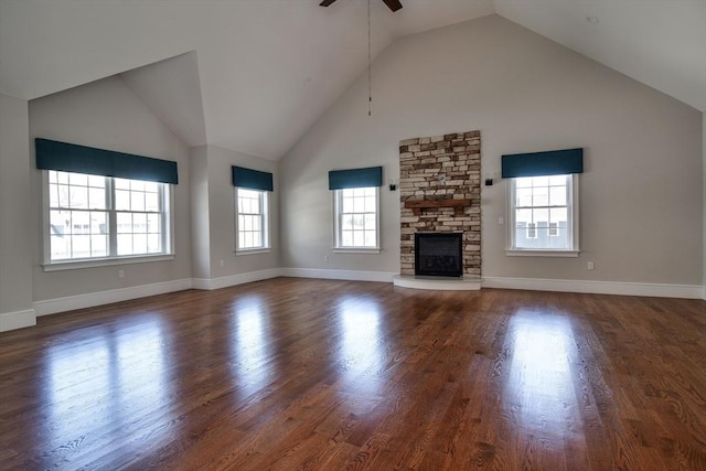 unfurnished living room featuring a ceiling fan, high vaulted ceiling, wood finished floors, and a fireplace