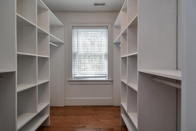 spacious closet featuring visible vents and wood finished floors