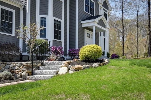 doorway to property featuring a lawn