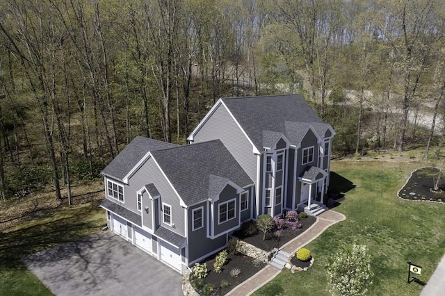 birds eye view of property featuring a view of trees