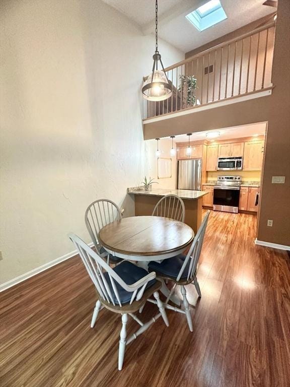 6 Tamarack Ln Unit 6, Peabody, MA 01960 - dining area with a skylight, wood finished floors, and high vaulted ceiling