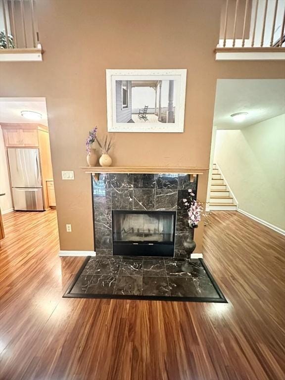 6 Tamarack Ln Unit 6, Peabody, MA 01960 - detailed view of freestanding refrigerator, wood finished floors, and a fireplace