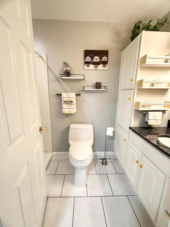 6 Tamarack Ln Unit 6, Peabody, MA 01960 - bathroom featuring vanity, tile patterned flooring, and a textured ceiling