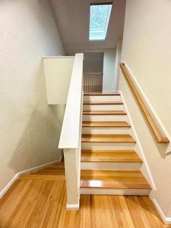 6 Tamarack Ln Unit 6, Peabody, MA 01960 - staircase with a skylight, wood finished floors, and a textured wall