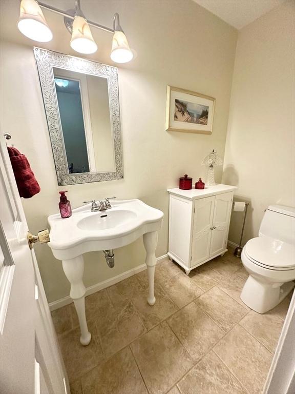 6 Tamarack Ln Unit 6, Peabody, MA 01960 - half bathroom with toilet and tile patterned floors