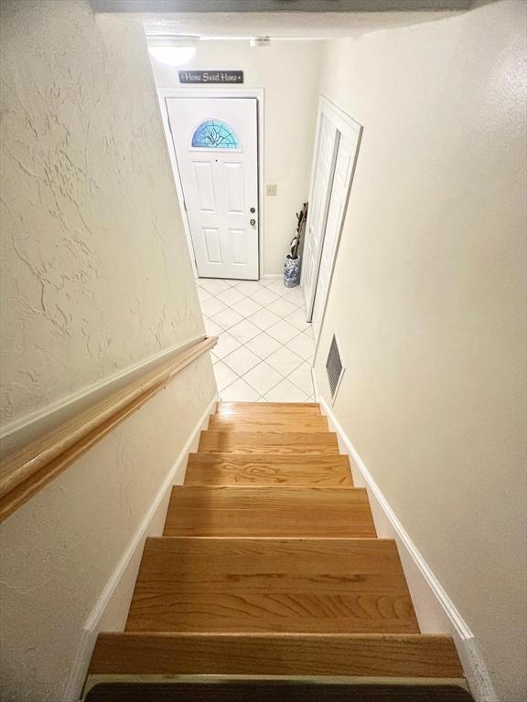 6 Tamarack Ln Unit 6, Peabody, MA 01960 - staircase featuring tile patterned flooring and a textured wall