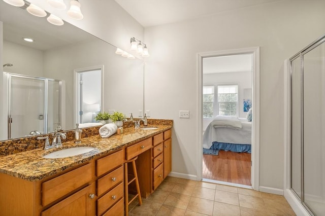 full bathroom with tile patterned flooring, a shower stall, ensuite bathroom, and a sink