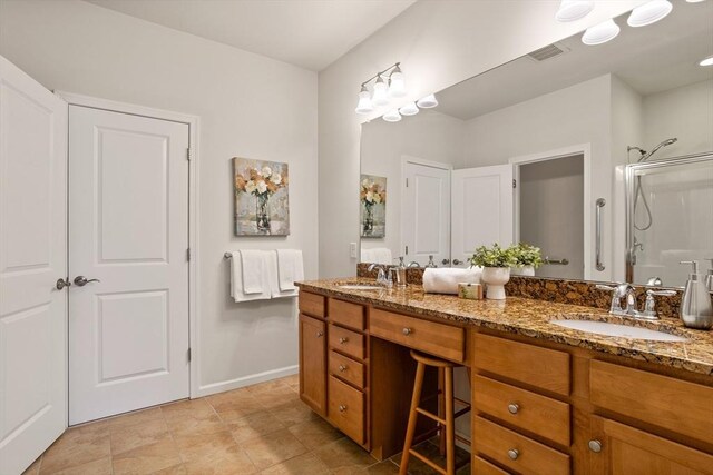 full bath featuring double vanity, visible vents, a stall shower, and a sink