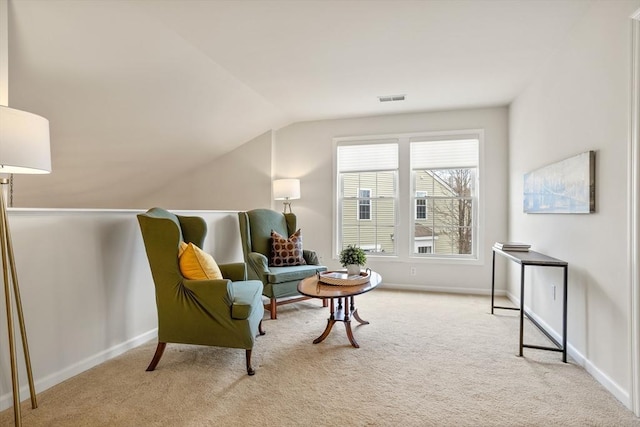 living area featuring visible vents, baseboards, lofted ceiling, and carpet