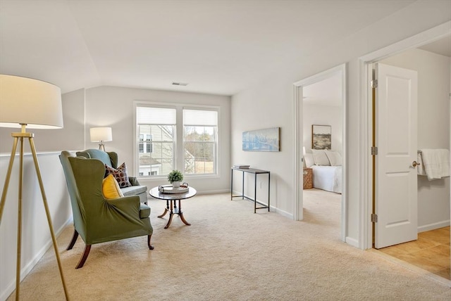 living area featuring carpet flooring, baseboards, lofted ceiling, and visible vents