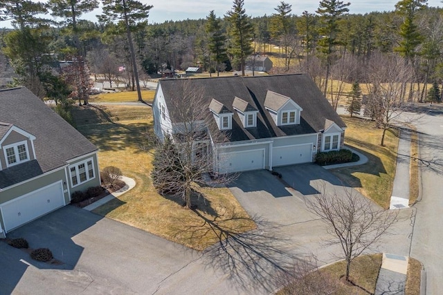 birds eye view of property featuring a view of trees