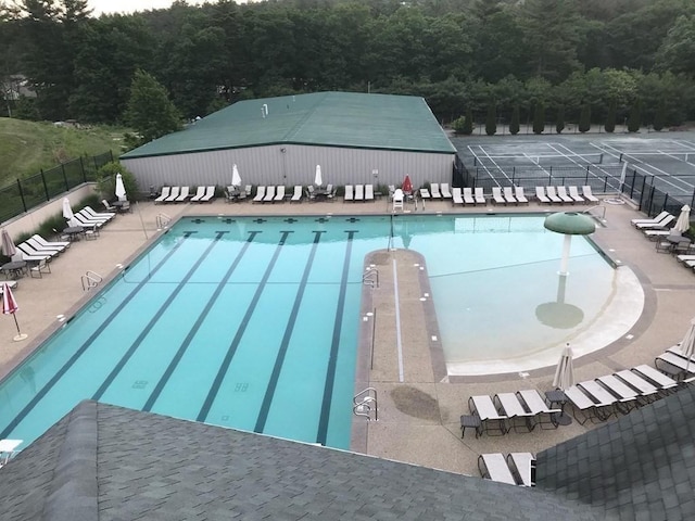 community pool featuring a patio area and fence