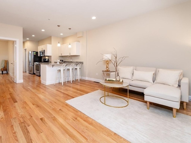 170 I St Unit 1, Boston, MA 02127 - living room featuring light wood-style flooring, baseboards, and recessed lighting