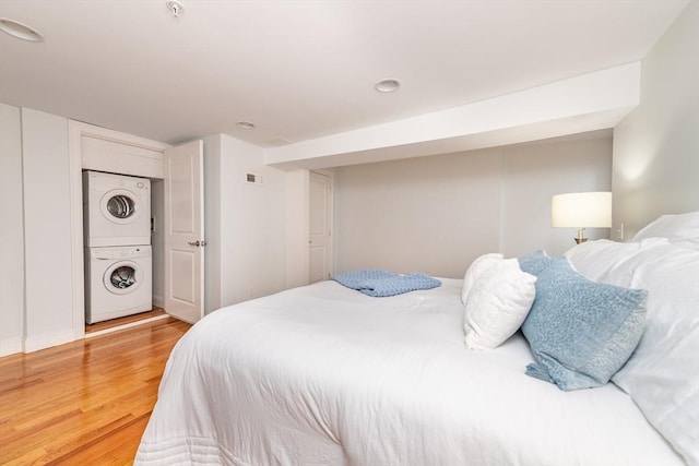 170 I St Unit 1, Boston, MA 02127 - bedroom with stacked washer and clothes dryer, light wood-type flooring, and recessed lighting