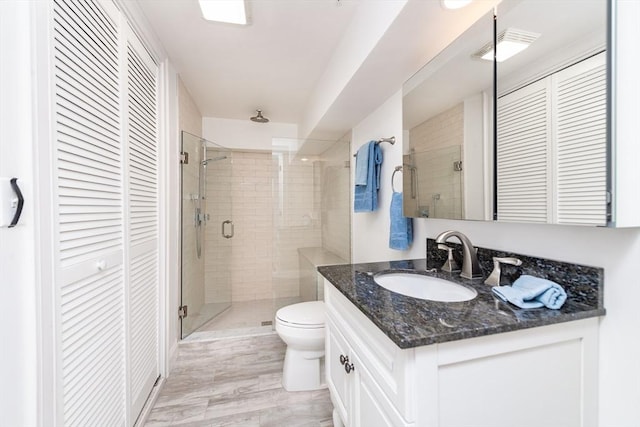 170 I St Unit 1, Boston, MA 02127 - bathroom featuring a closet, a stall shower, toilet, and vanity